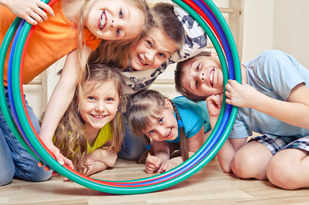 Kids smiling in hula hoops