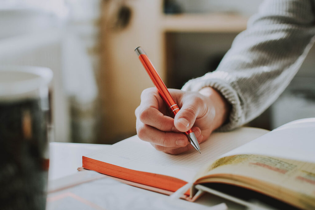 A Person Writing in their Journal